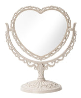 Our Cottagecore Vintage Style Heart Shaped Mirror is Intricately crafted with ornate floral and scrollwork detailing, giving the perfect, timeless cottagecore aesthetic. The silhouette adds a romantic touch to any vanity, bedroom, or entryway. 
The mirror is double sided with a magnifying area for detailed makeup application on one, making it a great addition to your beauty routine. An elegant but hip piece for many styles!