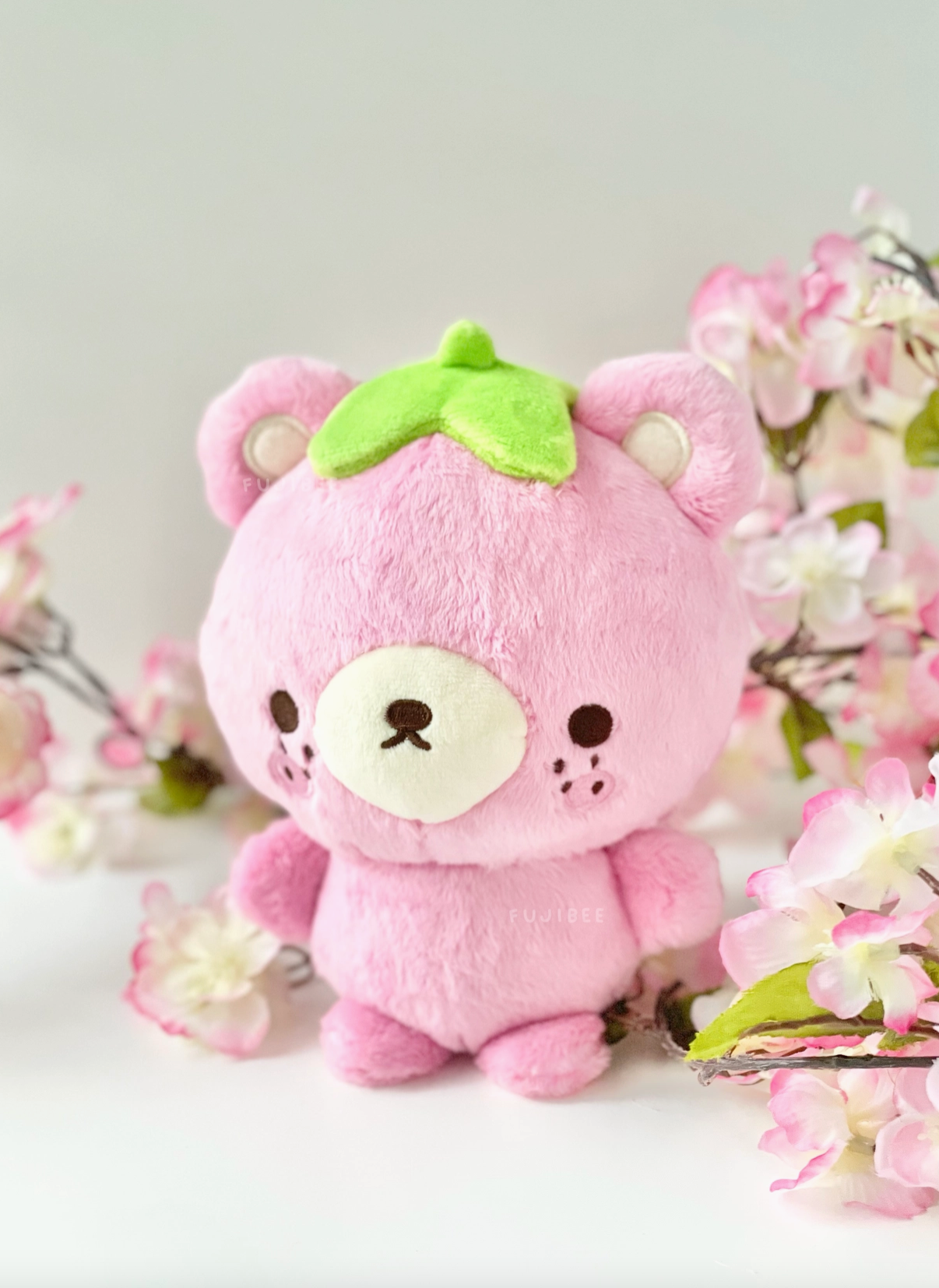 The Fujibee Barb the Strawberry Bear Plushie bursts with a berry cute personality! Residing in a cozy strawberry patch alongside her closest companion Lemon Bear, Barb is a unique plushie with eclectic tastes.