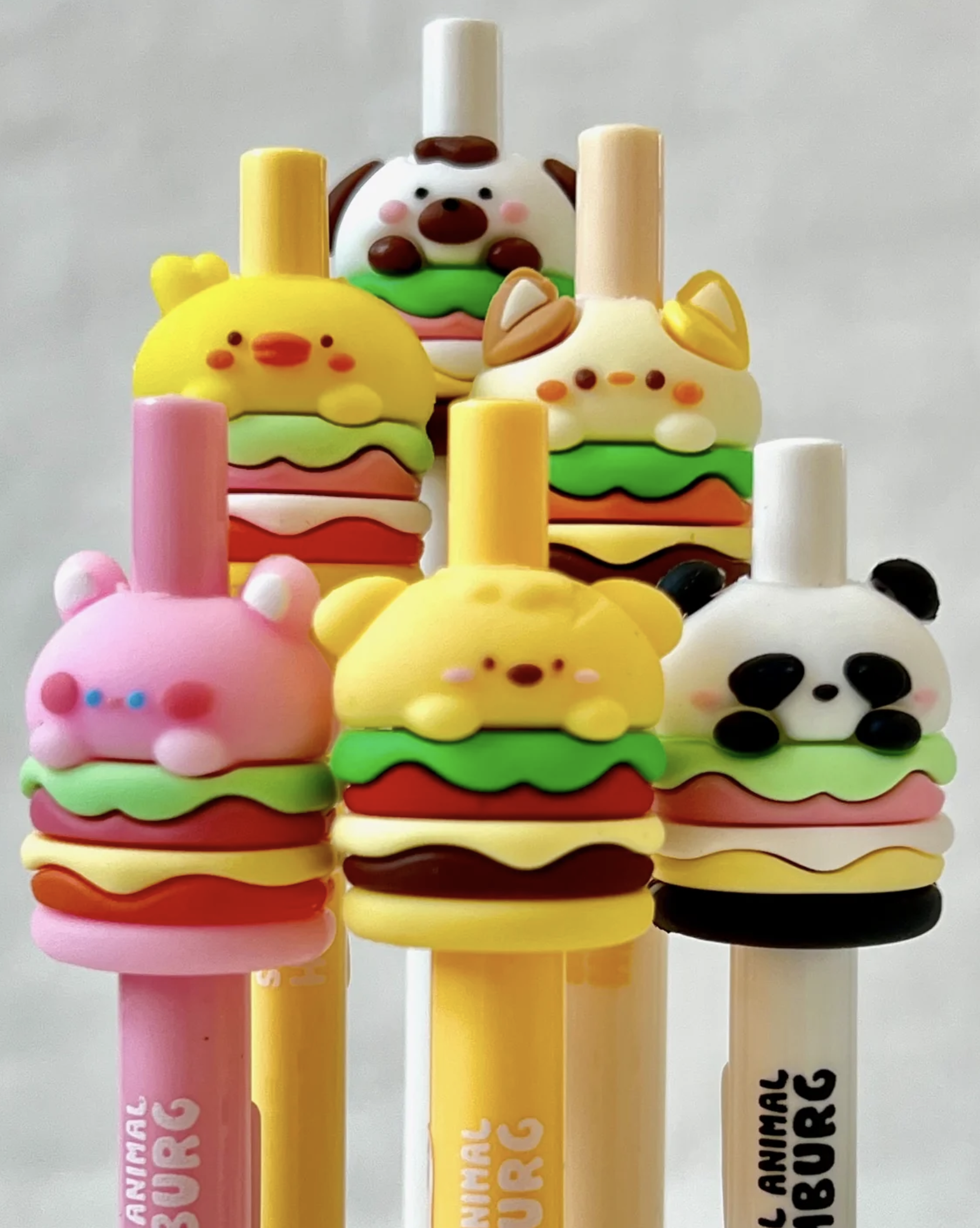 These amazingly cute Animal Burger Kawaii Fine Tip Gel Pens use a thick, opaque gel-based ink, combining the permanence of oil-based ballpoint ink with the smooth glide of water-based ink. A gel pen is the best solution when writing or illustrating on dark or slick surfaces, and having an ultra friendly lil burger buddy to keep you company while you work is always a great idea