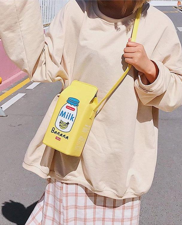 Sweeten your style with the Banana Milk Carton Kawaii Street Style Shoulder Bag playful and trendy accessory inspired by kawaii streetwear culture. Its unique milk carton shape and charming design make it the perfect statement piece for everyday wear or special outings.
