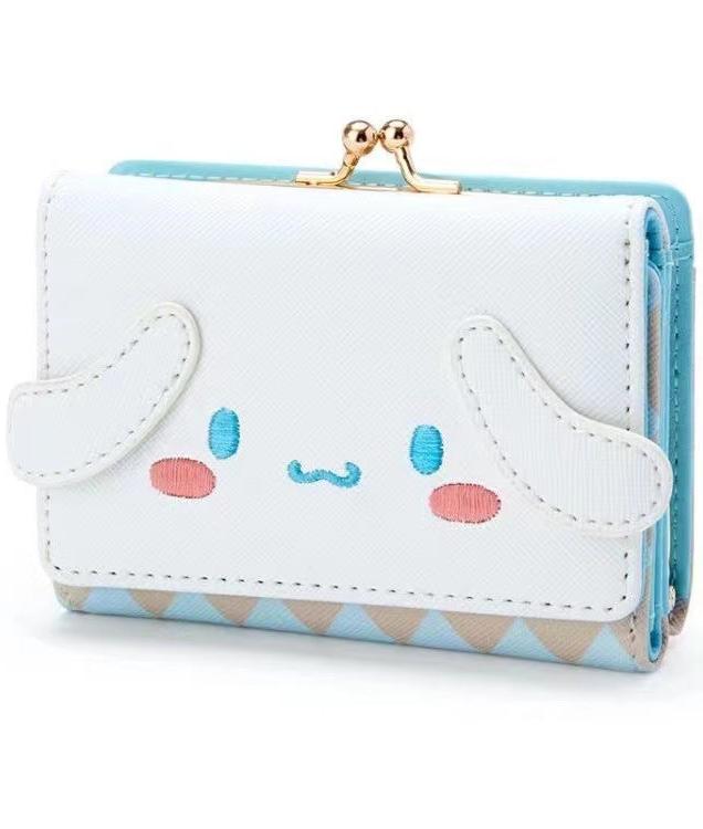 Add a touch of adorable charm to your daily essentials with this Cinnamoroll Face Baby Blue Diamond Print Wallet! Perfect for fans of the beloved Sanrio character, Cinnamoroll, this wallet is as functional as it is cute.

Featuring Cinnamoroll in a classy but fun baby blue diamond design, the wallet is accented with a stylish gold clasp, giving it a chic, feminine look.

Made from durable synthetic leather, with multiple compartments for cards, cash, and coins.