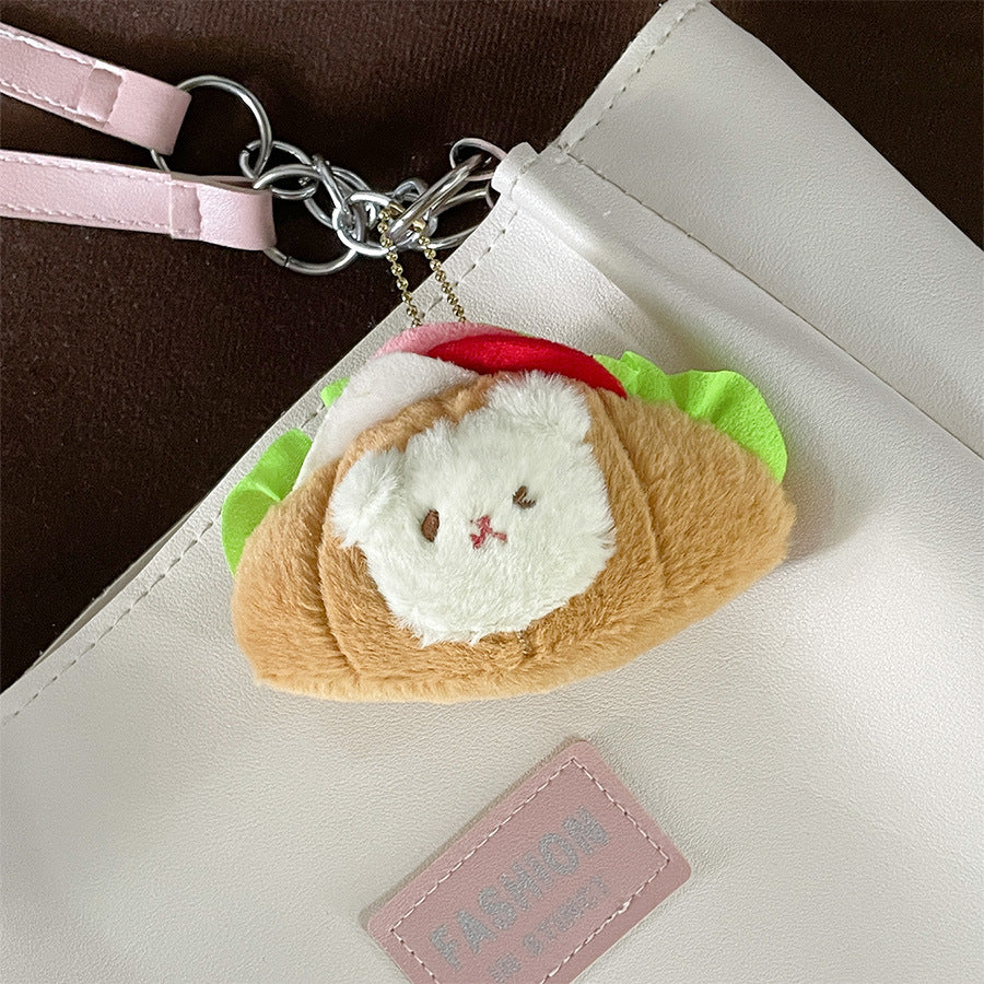 This little guy adds a dose of cute to your everyday carry with the Croissant Sandwich Bear Plush Keychain! This irresistibly cute accessory features a tiny, soft bear atop a buttery croissant sandwich, with all the fixin's. Perfect for fans of food-inspired designs, sandwich lovers, and all things bear-y-licious, this keychain brings all the kawaii charm.