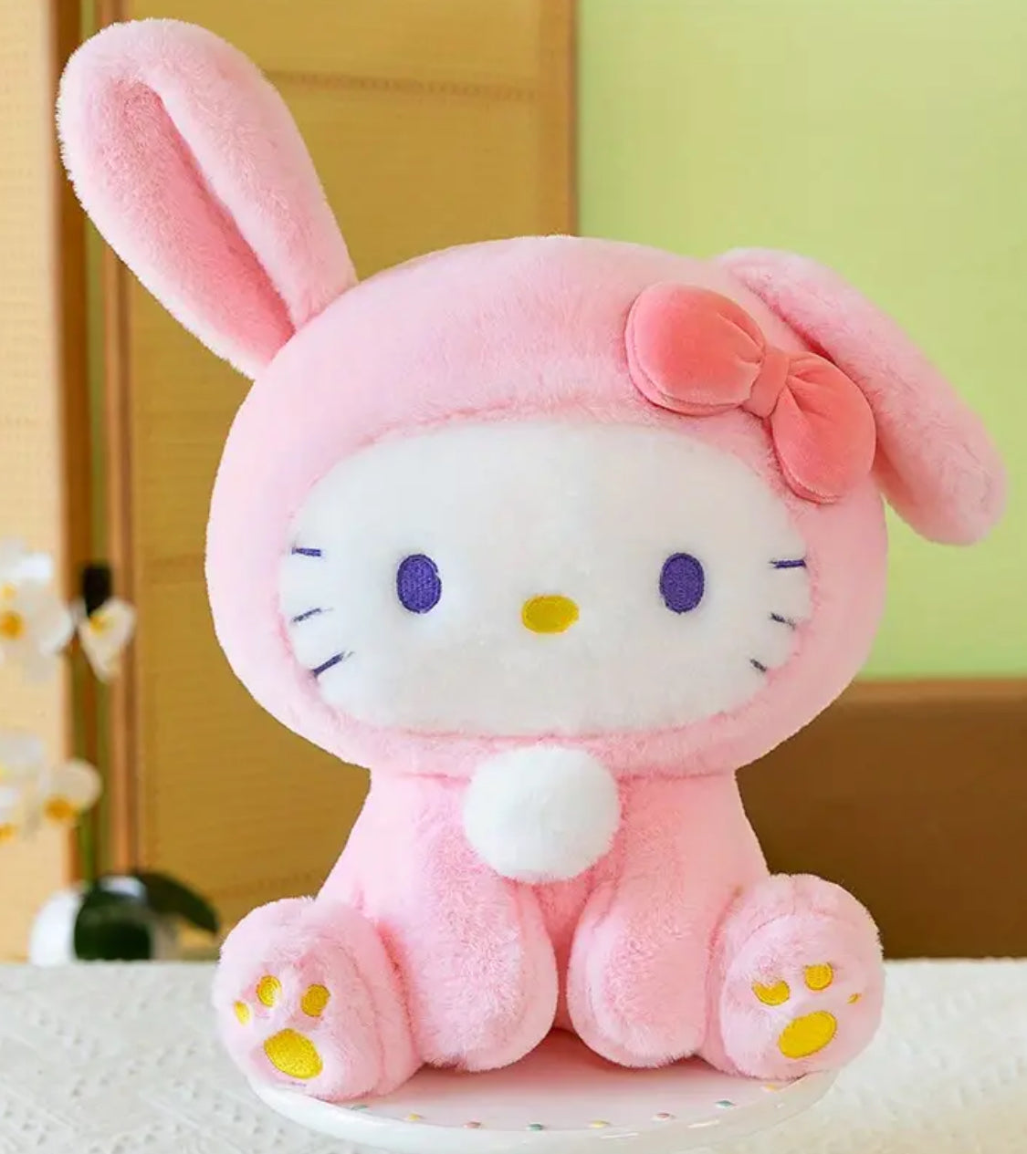 Meet the Curious Bunny Hello Kitty Plushie, a charming blend of Hello Kitty’s iconic style with an adorable bunny twist! This plushie features Hello Kitty wearing a cute bunny hoodie with one ear playfully perked up, giving her a curious and sweet expression.