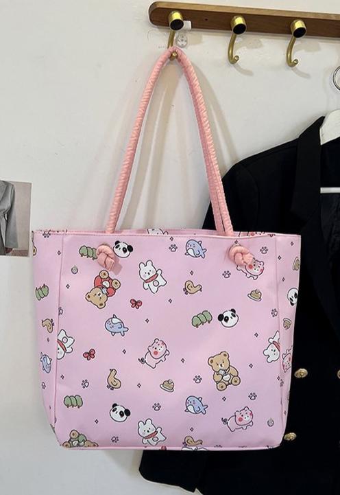 Fun, cute, and functional, this Everything Kawaii Print Shoulder Bag is a delightful bag featuring an enchanting all-over print. Showcasing adorable characters and designs: a playful panda, a cheerful bunny holding a carrot, a cuddly teddy bear, a narwhal with a magical horn, an all sorts of other whimsically happy delights!

This bag is perfect for school, work, or casual outings and is made from durable, nylon fabric with a soft pastel finish. It’s both stylish and practical with the double shoulder strap