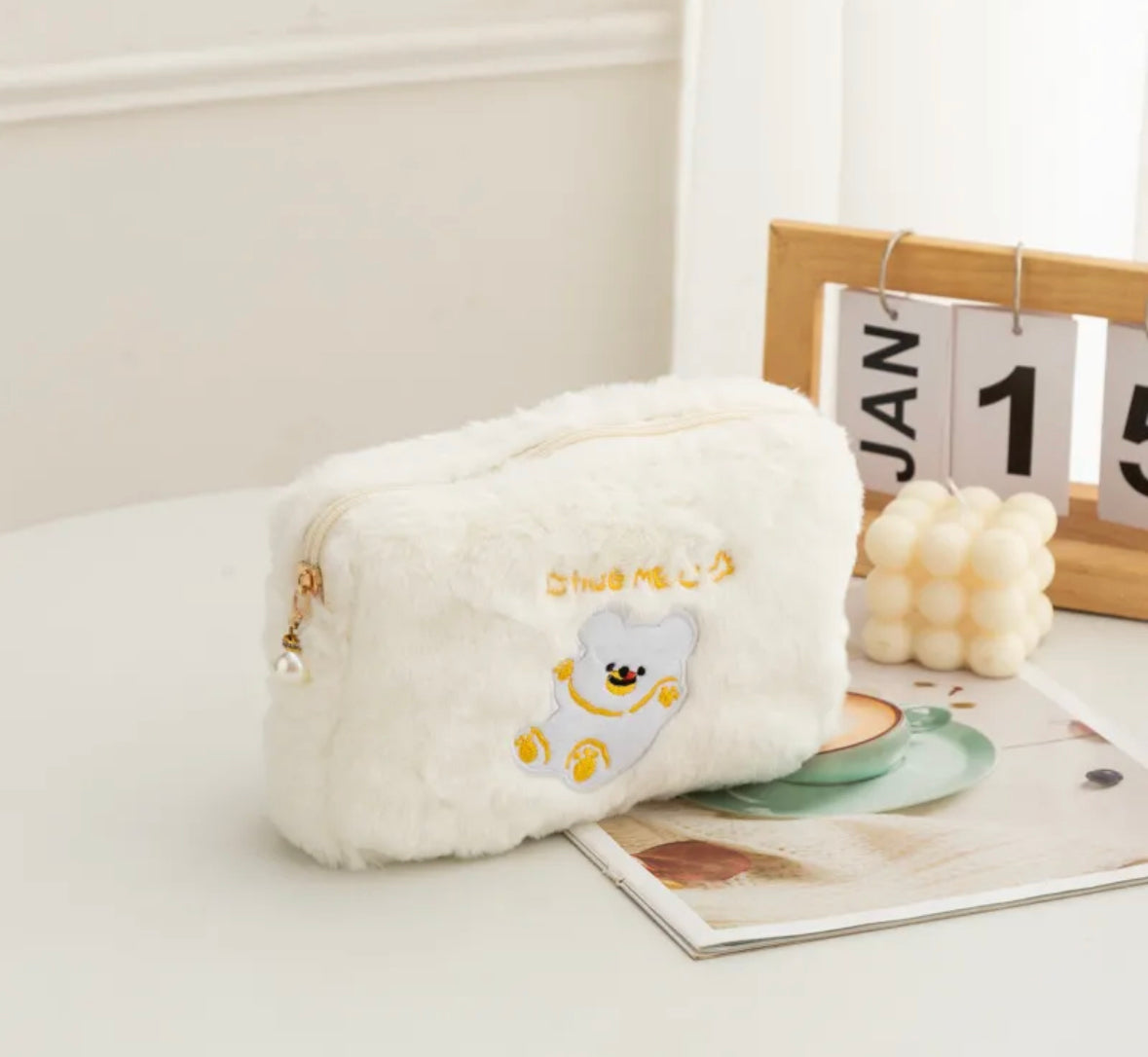 Perfectly sized for all your beauty essentials, these cosmetic bags are cute and functional, with a roomy interior and secure pearl-charmed zipper closure to keep your items organized and accessible.