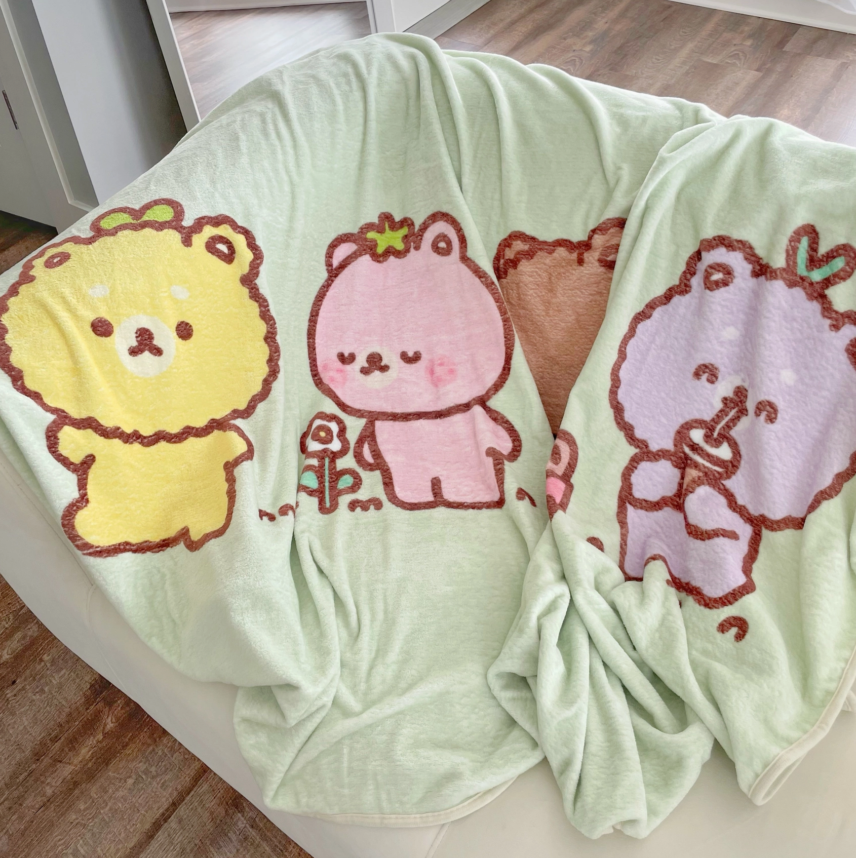 Wrap yourself in the cuddly charm of this Fluffy Bear Fleece Blanket! Illustrated with adorably plump bears by artist Chi Chi Little, this cozy blanket transforms any nap into a delightful experience.   Perfectly sized for a road trip snooze or a cozy night at home, it's the ultimate accessory for happy, restful moments. Boutique Kawaii