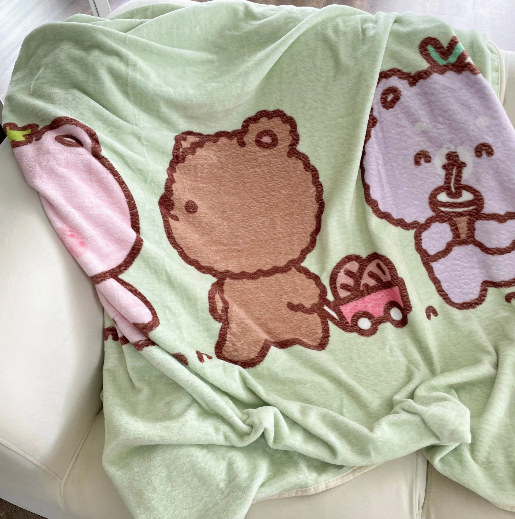 Wrap yourself in the cuddly charm of this Fluffy Bear Fleece Blanket! Illustrated with adorably plump bears by artist Chi Chi Little, this cozy blanket transforms any nap into a delightful experience.   Perfectly sized for a road trip snooze or a cozy night at home, it's the ultimate accessory for happy, restful moments. Boutique Kawaii