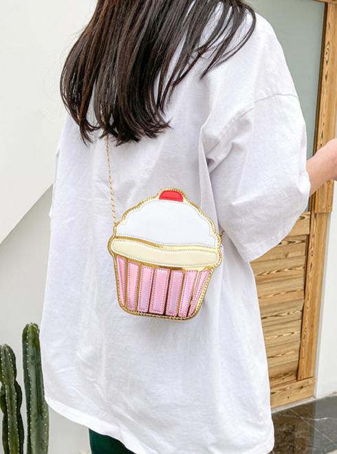 This delightful accessory is perfect for adding a playful yet chic touch to your outfit. Designed to resemble a frosted cupcake with shimmering gold detail, it’s a statement piece for anyone who loves kawaii style with a dash of glamour.

The Frosted Cupcake Gold Kawaii Street Style Purse features a rounded cupcake shape, complete with a fluffy pastel "frosting" top, a red cherry topping, and a metallic gold base that gleams in the light.