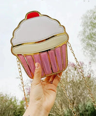 This delightful accessory is perfect for adding a playful yet chic touch to your outfit. Designed to resemble a frosted cupcake with shimmering gold detail, it’s a statement piece for anyone who loves kawaii style with a dash of glamour.

The Frosted Cupcake Gold Kawaii Street Style Purse features a rounded cupcake shape, complete with a fluffy pastel "frosting" top, a red cherry topping, and a metallic gold base that gleams in the light.