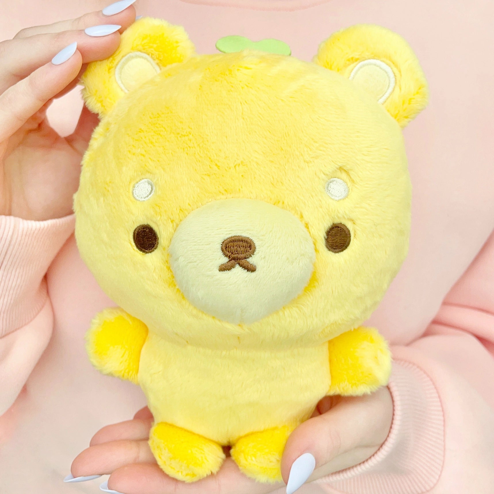 This cuddly boutique designed bear features exquisite embroidered details, capturing the essence of citrus brightness with his adorable lemon-themed vibed. Made from soft, huggable materials, Fujibee's Lemon Yellow Bear Boutique Plushie is perfect for snuggling up with! The cute green stem and leaf sprouting from its head is the sweetest detail!