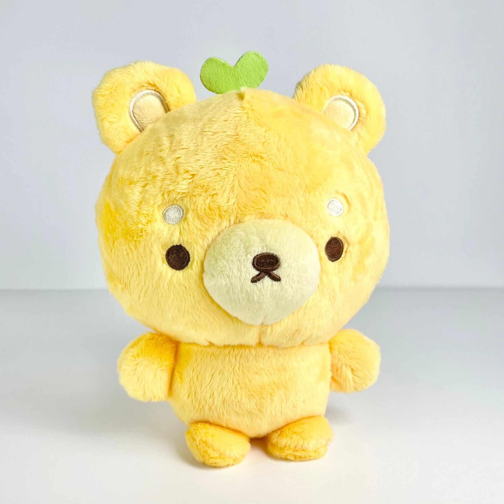 This cuddly boutique designed bear features exquisite embroidered details, capturing the essence of citrus brightness with his adorable lemon-themed vibed. Made from soft, huggable materials, Fujibee's Lemon Yellow Bear Boutique Plushie is perfect for snuggling up with! The cute green stem and leaf sprouting from its head is the sweetest detail!