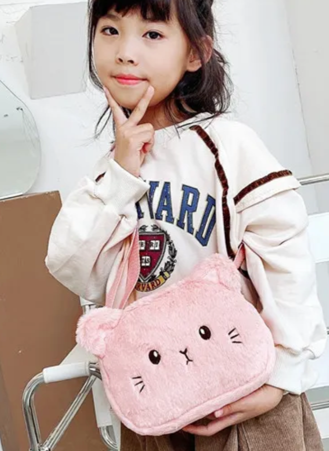 This charming accessory combines fashion with fun, featuring a delightful kitty design in soft, fuzzy pink fabric. Perfect for adding a touch of cuteness to any outfit, this plush purse is as practical as it is adorable. With its spacious interior and secure closure, it's ideal for carrying your essentials with ease and flair.