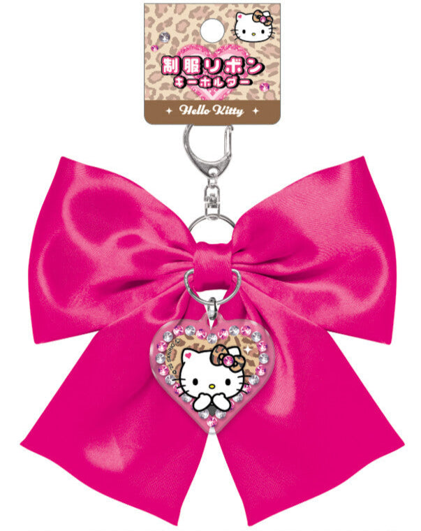 Elevate your everyday style with our Glam Hello Kitty Satin Bow Keychain in hot pink! This elegant accessory perfectly combines Sanrio's iconic charm with glam design elements. The stunning hot pink satin bow is complemented by a special centerpiece; a sparkling Hello Kitty acrylic charm that adds an extra touch of kawaii flair. Built with quality in mind, this keychain features a durable metal attachment that makes it perfect for your keys, bags, or starting your Sanrio collection.  