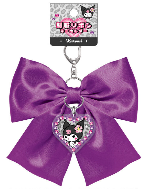 Elevate your everyday style with our Glam Kuromi Satin Bow Keychain in deep purple! This elegant accessory perfectly combines Sanrio's iconic charm with glam design elements. The stunning deep purple satin bow is complemented by a special centerpiece; a sparkling Kuromi acrylic charm that adds an extra touch of kawaii flair. Built with quality in mind, this keychain features a durable metal attachment that makes it perfect for your keys, bags, or starting your Sanrio collection.