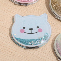 Upgrade your cosmetics collection with the Glitter Cat Pocket Double Sided Mirror. A leather looking base and a smiling feline face are covered by clear plastic, allowing for glitter to slide from side to side. It’s a little something pretty and a little something shiny to add boost to your day.