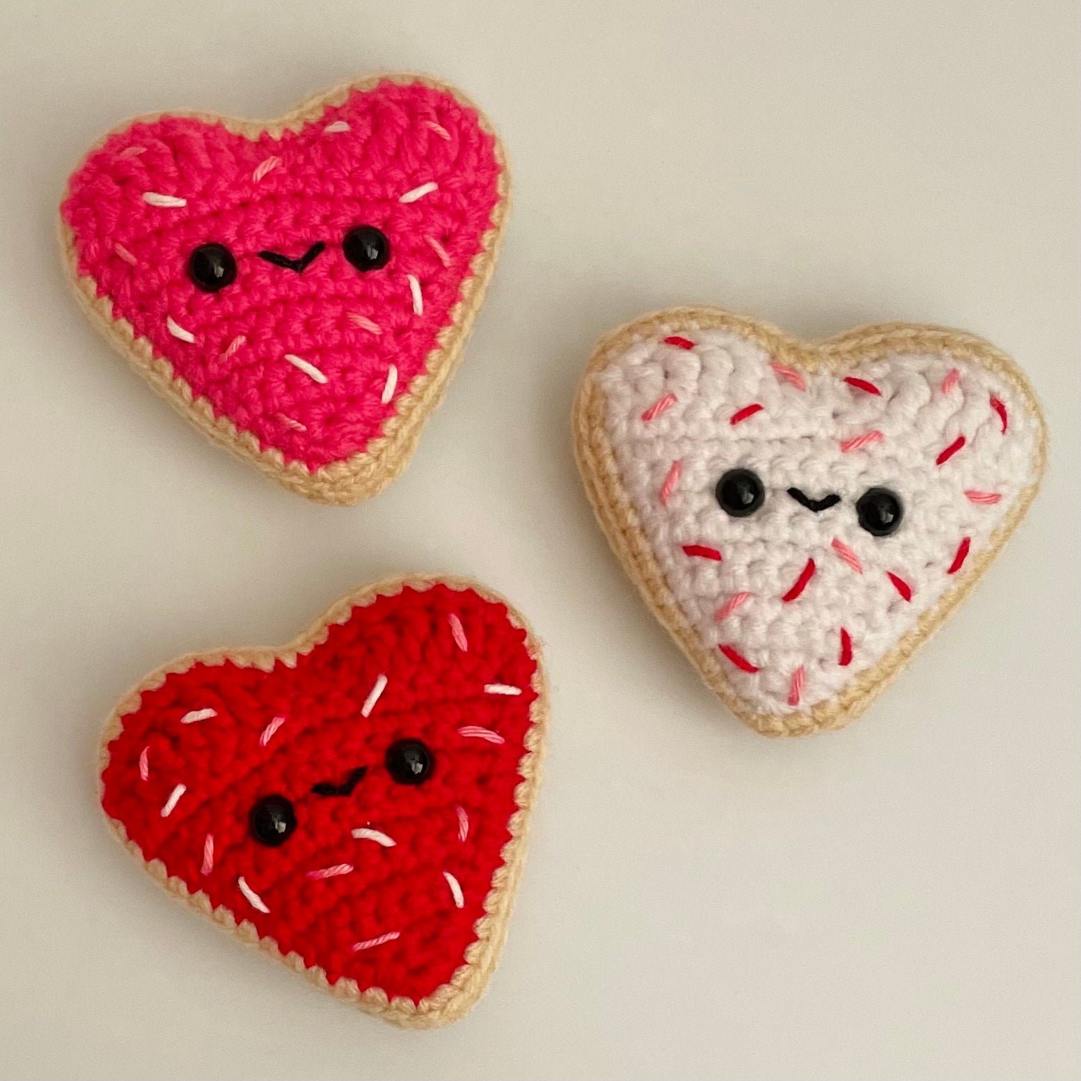 Indulge in sweetness with these Crocheted Heart-Shaped Sugar Cookies! Each cookie is lovingly crocheted with intricate detail, resembling the beloved classic treat.