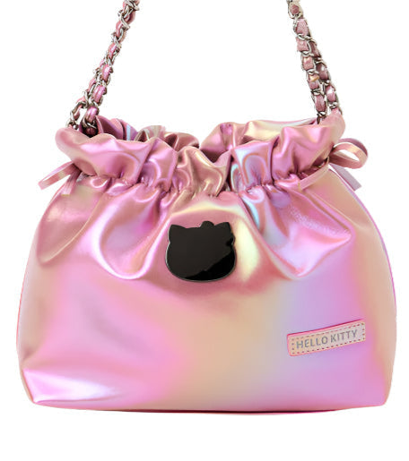 Class and shine meets everyday style with our Hello Kitty Pink Metallic Ribbon Shoulder Bag! This limited edition bag features a stunning silvery metallic finish that changes color at different angles, and is adorned with elegant ribbon details and an adorable Hello Kitty charm. The practical drawstring cinch closure keeps your belongings secure while maintaining easy access. Perfectly sized for daily essentials and featuring a comfortable shoulder strap, this bag combines functionality with kawaii flair. 
