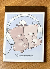 This charming kawaii notepad showcases buddies doing what buddies do-- sharing their favorite stuffs, especially music via headphones! This is a cute pick me up gift for yourself or another music afficionado. Everyone's needing to keep notes, grand or small, and why not color your day with a sweet design to do so?

This delightful piece will add a touch of musical fun to your stationery collection, making every note feel special.