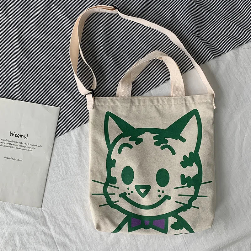 A fabulous mix of Japanese manga and American pop art styles, Japanese illustrator Osamu Harada created some of the most iconic kawaii designs of the 1980s. These Japanese Pop Art Cat Face Tote Bag by Osamu Goods feature his wholesome but edgy designs in a fabulous larger sized canvas tote with silkscreened happy cat face, one of his most famous iconic designs.