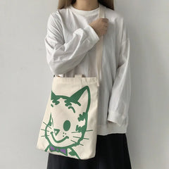 A fabulous mix of Japanese manga and American pop art styles, Japanese illustrator Osamu Harada created some of the most iconic kawaii designs of the 1980s. These Japanese Pop Art Cat Face Tote Bag by Osamu Goods feature his wholesome but edgy designs in a fabulous larger sized canvas tote with silkscreened happy cat face, one of his most famous iconic designs.