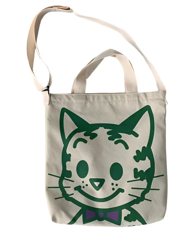 A fabulous mix of Japanese manga and American pop art styles, Japanese illustrator Osamu Harada created some of the most iconic kawaii designs of the 1980s. These Japanese Pop Art Cat Face Tote Bag by Osamu Goods feature his wholesome but edgy designs in a fabulous larger sized canvas tote with silkscreened happy cat face, one of his most famous iconic designs.