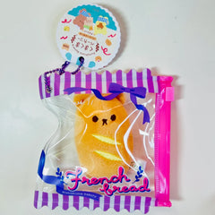 Say hello to the cutest little snack to carry your essentials! This unique Kuma Bakery Bear in a Bag Keychain French Baguette features a soft, squishy bear bread plushie tucked inside a charming purple-and-white striped mini wallet. The softness is like a mochi dessert and design is unmatched.