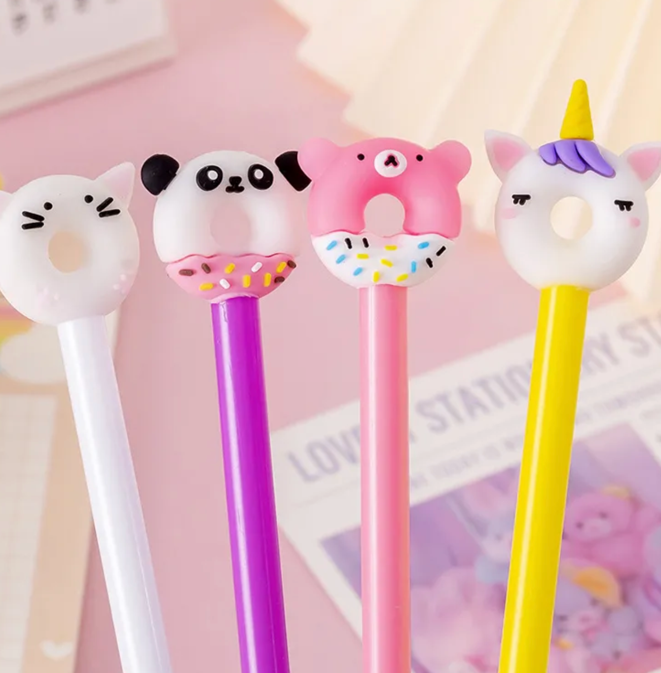 Our Kawaii Donut Animals Gel Pen Set includes four pens in various happy color palettes of white, purples, pinks, and yellow. These pens provide a smooth writing experience for those who like a gel ink tip.