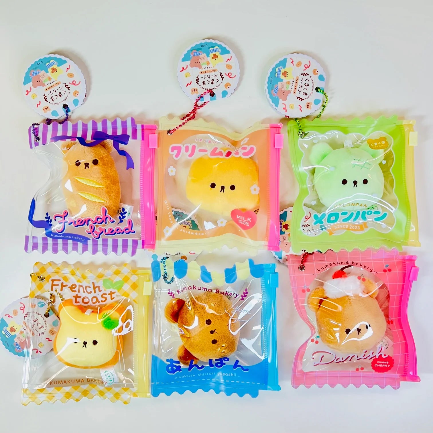 Say hello to the cutest little snack to carry your essentials! This unique Kuma Bakery Bear in a Bag Keychain features a soft, squishy bread bear plushie tucked inside a charming clear and blue mini wallet. The softness is like a mochi dessert and the design is unmatched.