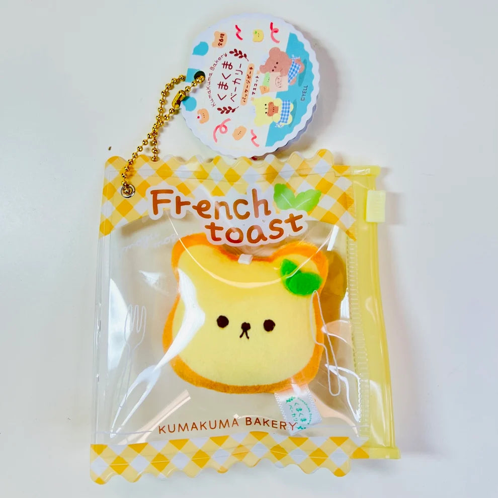 Say hello to the cutest little snack to carry your essentials! This unique Kuma Bakery Bear in a Bag Keychain, French Toast features a soft, squishy bread bear plushie tucked inside a charming clear and yellow checkered themed mini wallet. The softness is like a mochi dessert and the design is unmatched.