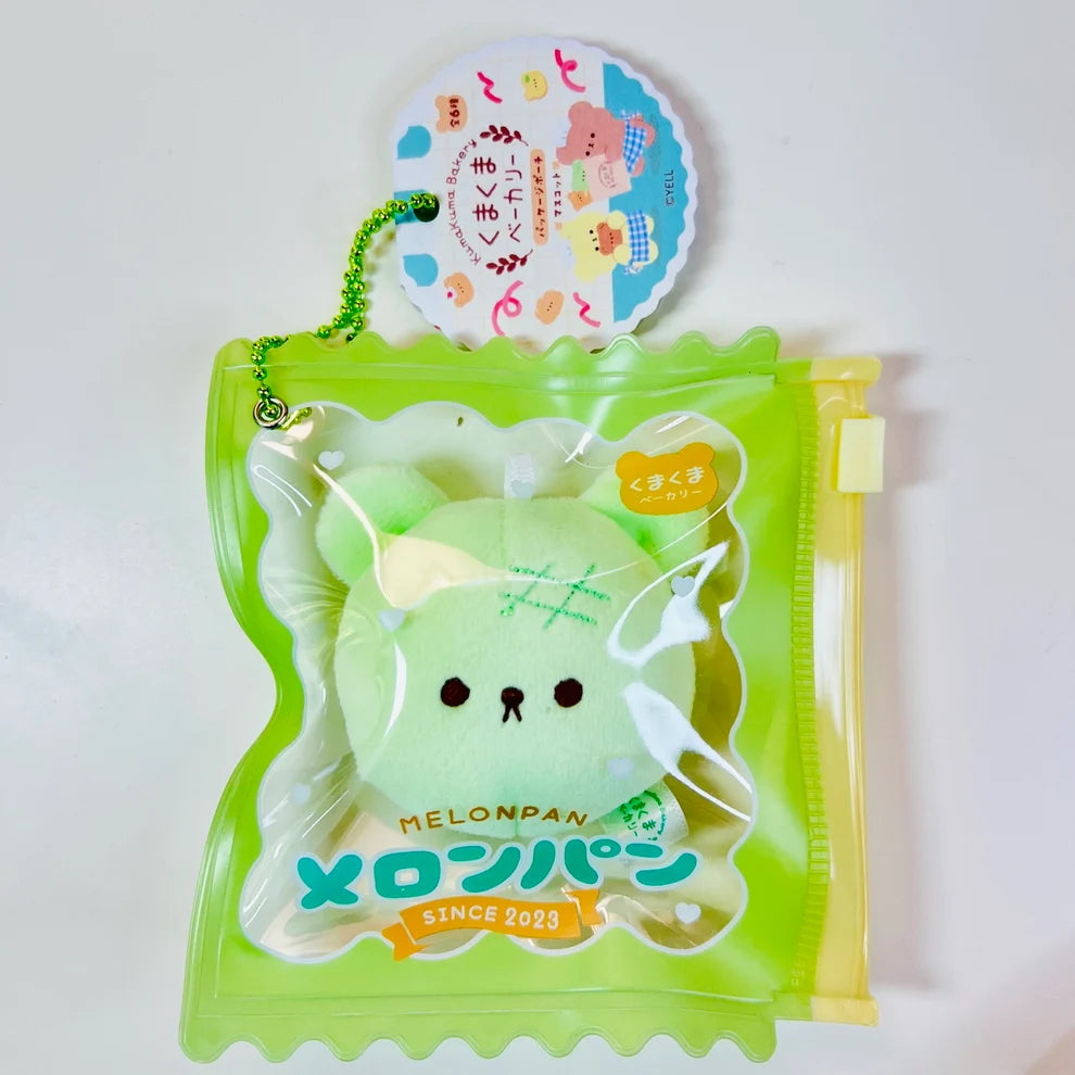 Say hello to the cutest little snack to carry your essentials! This unique Kuma Bakery Bear in a Bag Keychain, Melon Pan features a soft, squishy bear bread plushie tucked inside a charming clear and green mini wallet. The softness is like a mochi dessert and design is unmatched. Kawaii means cute in Japanese and this plushie keychain is as kawaii as you can get!