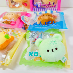 Say hello to the cutest little snack to carry your essentials! This unique Kuma Bakery Bear in a Bag Keychain, Melon Pan features a soft, squishy bear bread plushie tucked inside a charming clear and green mini wallet. The softness is like a mochi dessert and design is unmatched. Kawaii means cute in Japanese and this plushie keychain is as kawaii as you can get!