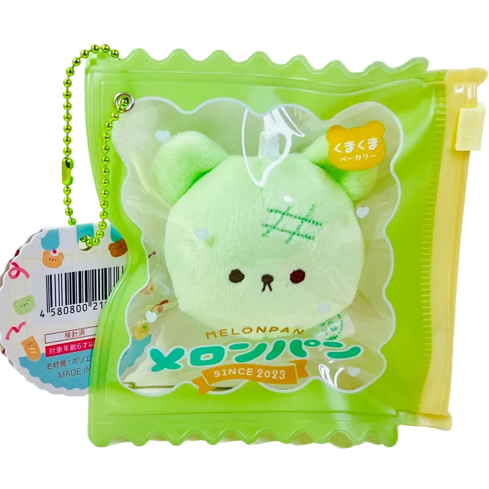 Say hello to the cutest little snack to carry your essentials! This unique Kuma Bakery Bear in a Bag Keychain, Melon Pan features a soft, squishy bear bread plushie tucked inside a charming clear and green mini wallet. The softness is like a mochi dessert and the design is unmatched. Kawaii means cute in Japanese and this plushie keychain is as kawaii as you can get!