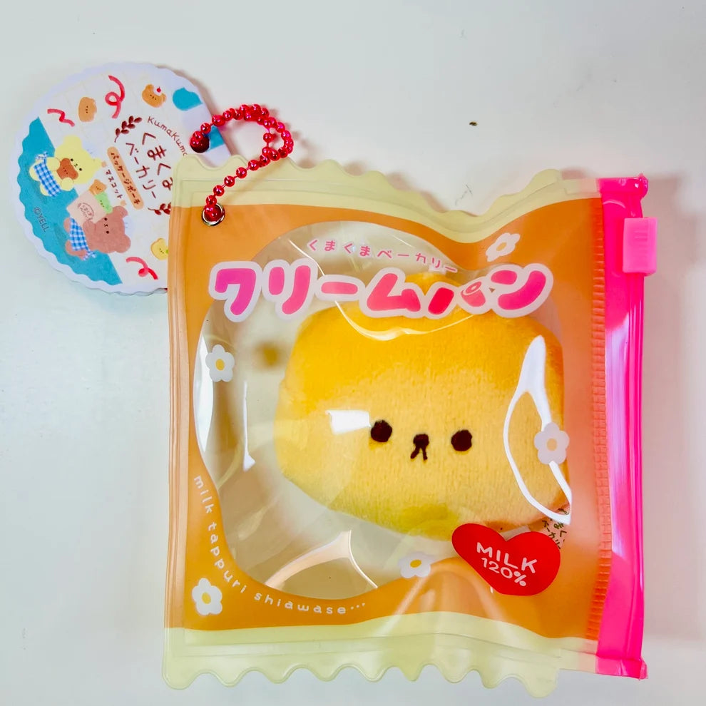 Say hello to the cutest little snack to carry your essentials! This unique Kuma Bakery Bear in a Bag Keychain, Milk Bread features a soft, squishy bread bear plushie tucked inside a charming clear and multi color mini wallet. The softness is like a mochi dessert and the design is unmatched.