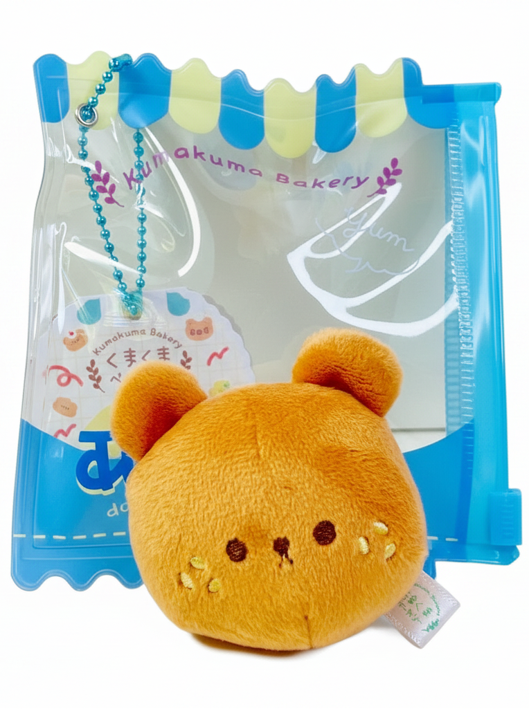 Say hello to the cutest little snack to carry your essentials! This unique Kuma Bakery Bear in a Bag Keychain, Sesame Bun features a soft, squishy bread bear plushie tucked inside a charming clear and blue mini wallet. The softness is like a mochi dessert and the design is unmatched.