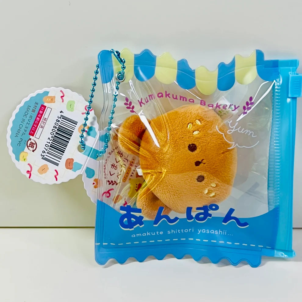 Say hello to the cutest little snack to carry your essentials! This unique Kuma Bakery Bear in a Bag Keychain, Sesame Bun features a soft, squishy bread bear plushie tucked inside a charming clear and blue mini wallet. The softness is like a mochi dessert and the design is unmatched.