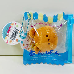 Say hello to the cutest little snack to carry your essentials! This unique Kuma Bakery Bear in a Bag Keychain, Sesame Bun features a soft, squishy bread bear plushie tucked inside a charming clear and blue mini wallet. The softness is like a mochi dessert and the design is unmatched.