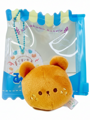Say hello to the cutest little snack to carry your essentials! This unique Kuma Bakery Bear in a Bag Keychain, Sesame Bun features a soft, squishy bread bear plushie tucked inside a charming clear and blue mini wallet. The softness is like a mochi dessert and the design is unmatched.