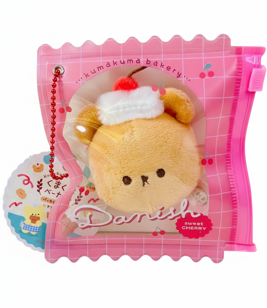 Say hello to the cutest little snack to carry your essentials! This unique Kuma Bakery Bear in a Bag Keychain, Sweet Cherry Danish features a soft, squishy bread bear plushie tucked inside a charming clear and pink mini wallet. The softness is like a mochi dessert and the design is unmatched.