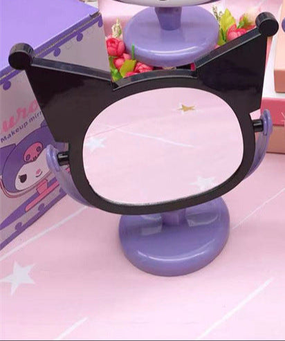 Mirror, mirror, with Kuromi flair - who's the most kawaii of them all? You are, of course! Especially with this absolutely adorable Kuromi Face Rotating Vanity Mirror by your side!

This two-sided beauty essential features our favorite rebel princess Kuromi in a striking black and purple design that'll make your vanity space totally social-media-worthy. One side offers regular reflection for your everyday glam, while the other features My Melody's face.