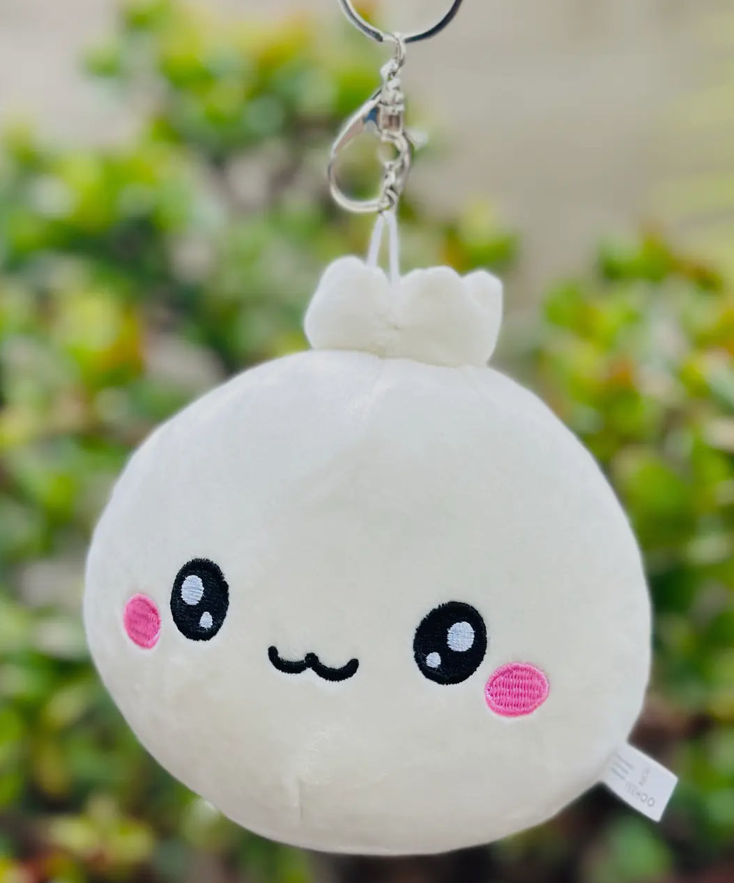 Discover the charm of our Lil Dumpling Bao Plush Keychain, a delightful and versatile accessory. This adorable plushie, designed to look like a cute, fluffy bao dumpling, features a removable keychain.

Use it as a quirky keychain, a charming bag accessory, or simply as a cuddly mini plushie. Its soft fabric and charming design make it perfect for food enthusiasts and fans of cute collectibles alike, offering three ways to bring a touch of joy to your daily routine.