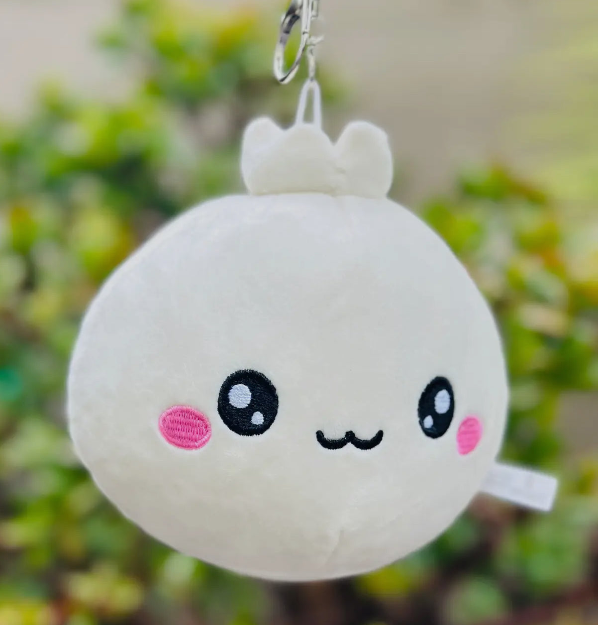 Discover the charm of our Lil Dumpling Bao Plush Keychain, a delightful and versatile accessory. This adorable plushie, designed to look like a cute, fluffy bao dumpling, features a removable keychain.

Use it as a quirky keychain, a charming bag accessory, or simply as a cuddly mini plushie. Its soft fabric and charming design make it perfect for food enthusiasts and fans of cute collectibles alike, offering three ways to bring a touch of joy to your daily routine.