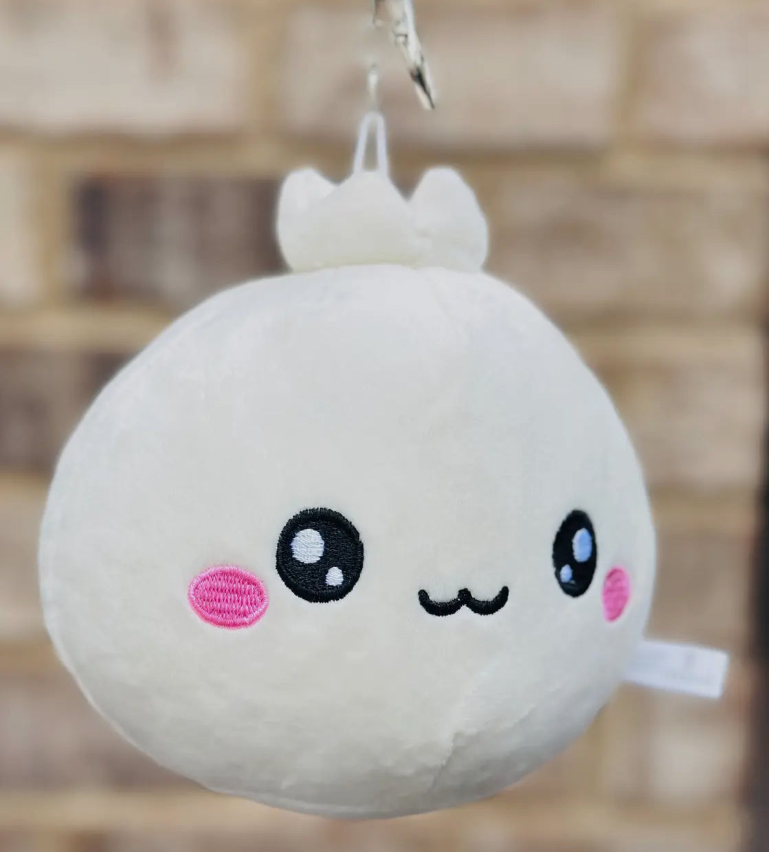 Discover the charm of our Lil Dumpling Bao Plush Keychain, a delightful and versatile accessory. This adorable plushie, designed to look like a cute, fluffy bao dumpling, features a removable keychain.

Use it as a quirky keychain, a charming bag accessory, or simply as a cuddly mini plushie. Its soft fabric and charming design make it perfect for food enthusiasts and fans of cute collectibles alike, offering three ways to bring a touch of joy to your daily routine.