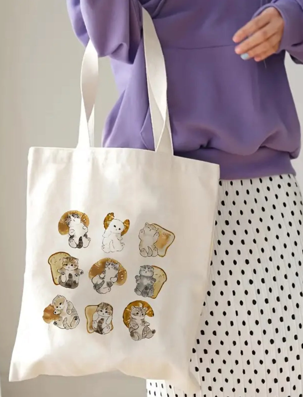 The Mofusand Cats, Croissants, &amp; Toast Tote Bag is the purr-fect accessory for cat lovers and foodies alike! Simple and quick, this adorable tote features playful illustrations of Mofusand's beloved chubby cats mingling with flaky croissants and toasty slices of bread.

Made from durable, eco-friendly poly-canvas, it’s spacious enough to carry your daily essentials, groceries, or books with style. With its cute design and sturdy construction, this bag brings a little extra charm to your everyday adventu