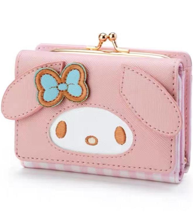 Add a touch of adorable charm to your daily essentials with this My Melody Face Pink Gingham Print Wallet! Perfect for fans of the beloved Sanrio character, My Melody, this wallet is as functional as it is cute.

Featuring My Melody in a classy but fun pink gingham design, the wallet is accented with a stylish gold clasp, giving it a chic, feminine look.

Made from durable synthetic leather, with multiple compartments for cards, cash, and coins.