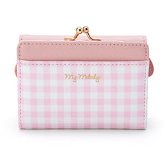 Add a touch of adorable charm to your daily essentials with this My Melody Face Pink Gingham Print Wallet! Perfect for fans of the beloved Sanrio character, My Melody, this wallet is as functional as it is cute.

Featuring My Melody in a classy but fun pink gingham design, the wallet is accented with a stylish gold clasp, giving it a chic, feminine look.

Made from durable synthetic leather, with multiple compartments for cards, cash, and coins.