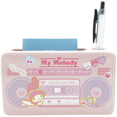 Add a touch of nostalgia to your workspace with this collectible My Melody Porcelain Boombox 90s Style Desk Organizer.

This charming organizer features the beloved Sanrio character in a retro design, perfect for fans of the 90s aesthetic. With compartments for pens, and even your phone, it's a functional and adorable addition to any desk.