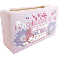 Add a touch of nostalgia to your workspace with this collectible My Melody Porcelain Boombox 90s Style Desk Organizer.

This charming organizer features the beloved Sanrio character in a retro design, perfect for fans of the 90s aesthetic. With compartments for pens, and even your phone, it's a functional and adorable addition to any desk.