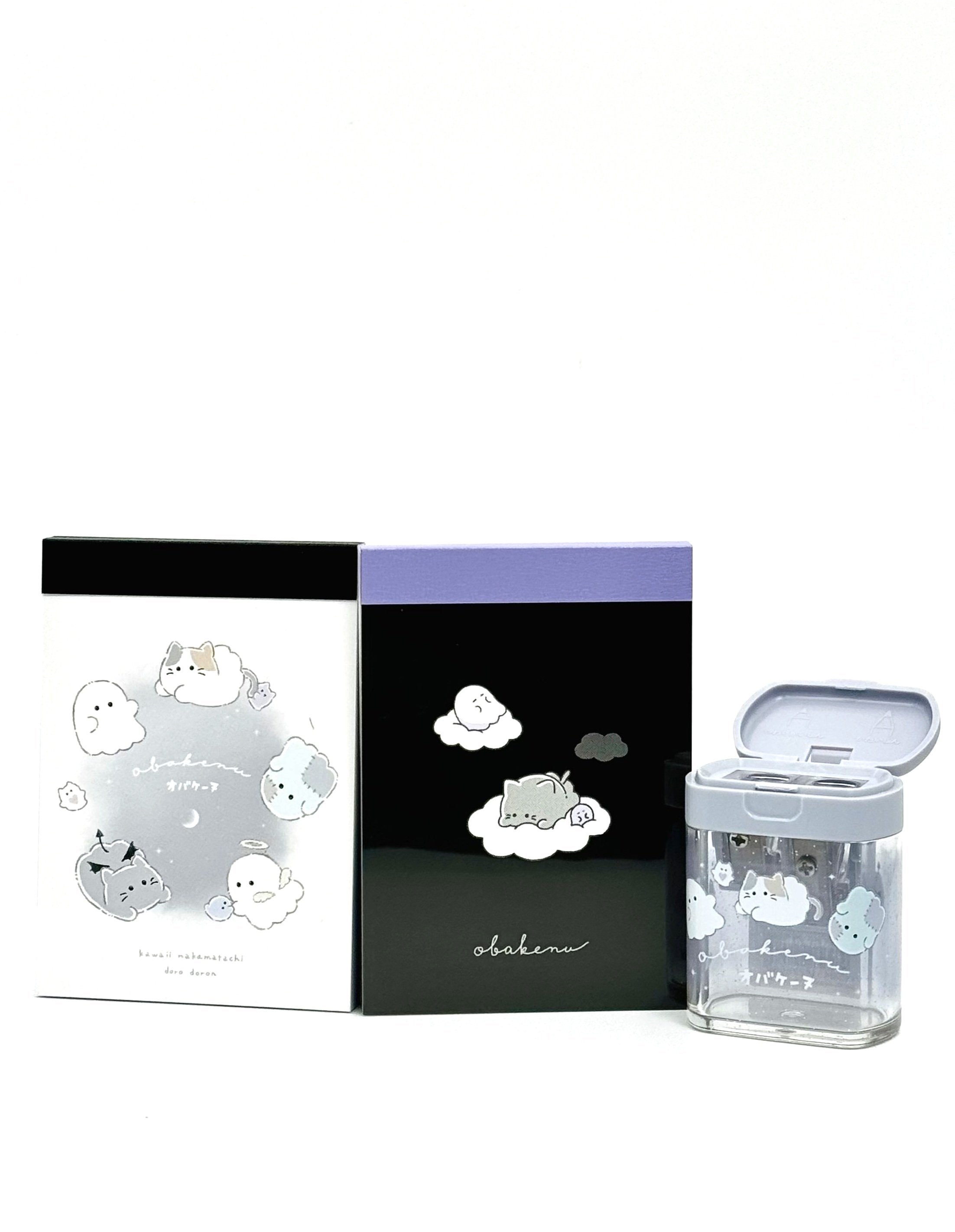 Obakane Ghost Stationary Set feature two notebooks with two different designs, printed in full color. Quality and chic holographic binding, yet easy tear-out sheets. A stand-up pencil sharpener featuring ghosts, cats, and dogs completes the set.