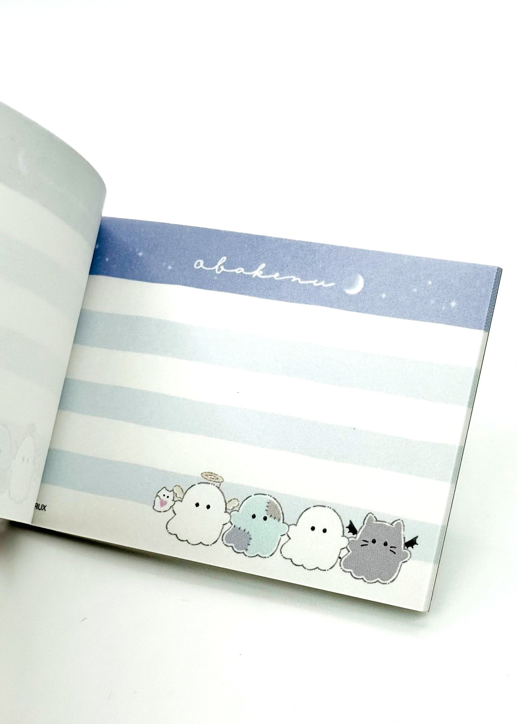 Obakane Ghost Stationary Set feature two notebooks with two different designs, printed in full color. Quality and chic holographic binding, yet easy tear-out sheets. A stand-up pencil sharpener featuring ghosts, cats, and dogs completes the set.