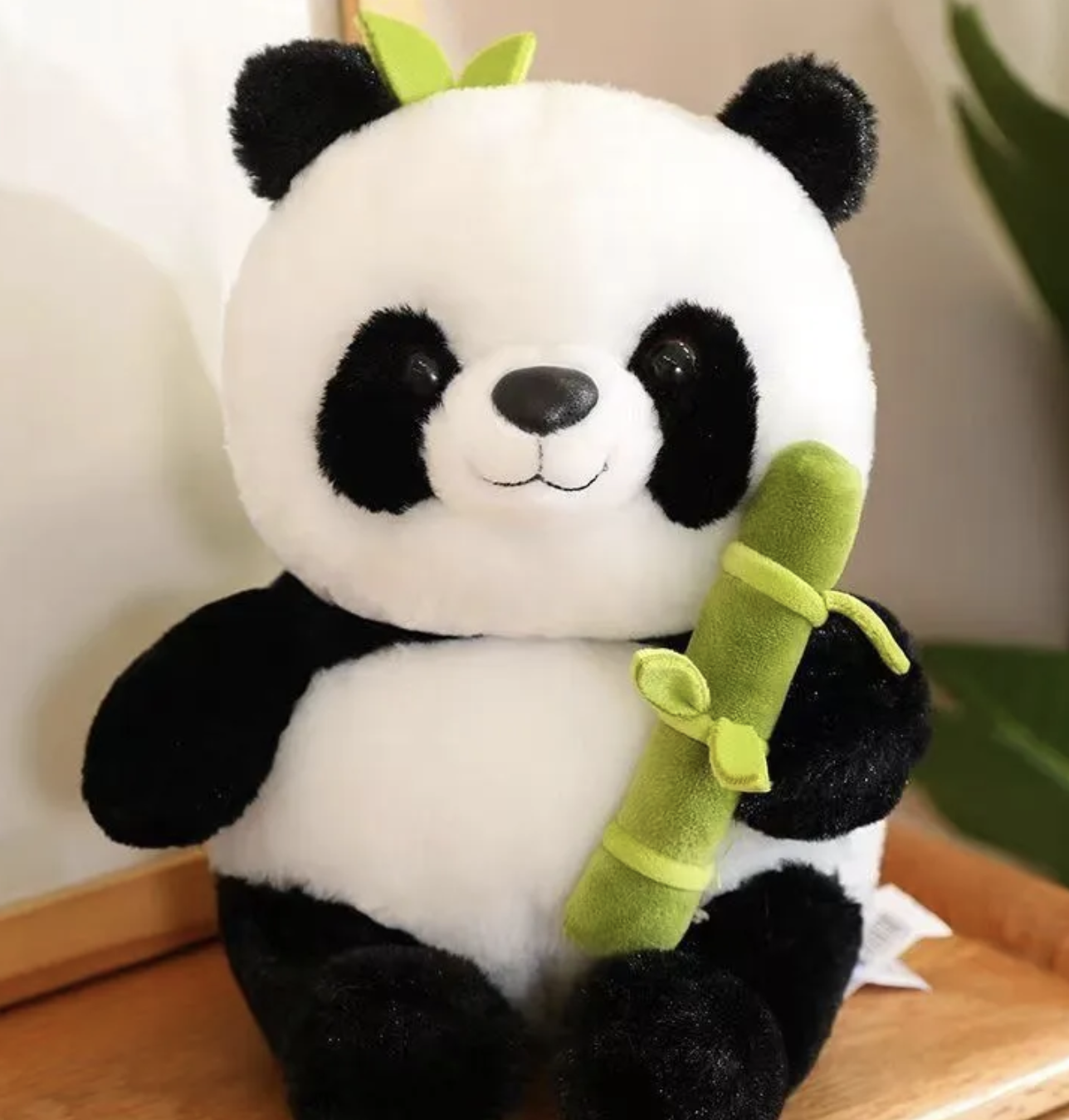 With its soft black and white fur and gentle expression, the Panda Plushie in Zippered Bamboo Shoot exudes warmth and tranquility. Whether it's used as a cuddly companion for cozy nights in or as a charming accent to brighten up any room, this plush panda promises to bring joy to all who encounter it.